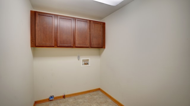 clothes washing area featuring gas dryer hookup, cabinets, and washer hookup