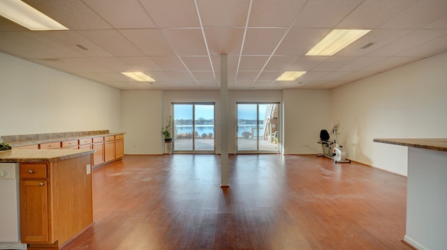 interior space featuring light hardwood / wood-style floors and a drop ceiling