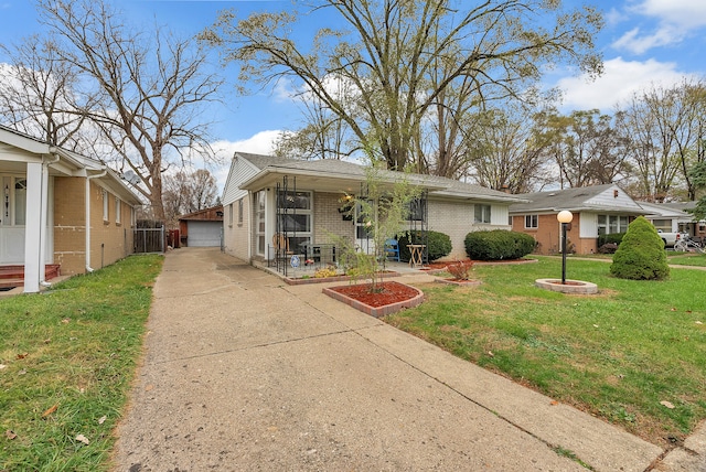 view of front of house featuring a front yard, a porch, a garage, and an outdoor structure