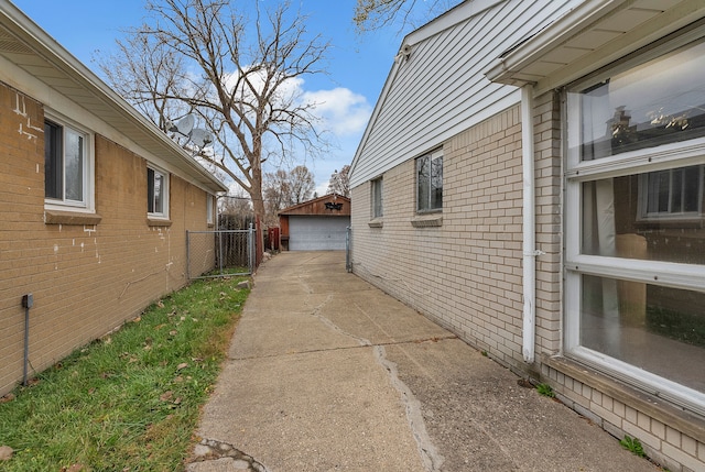 view of property exterior with a garage and an outdoor structure