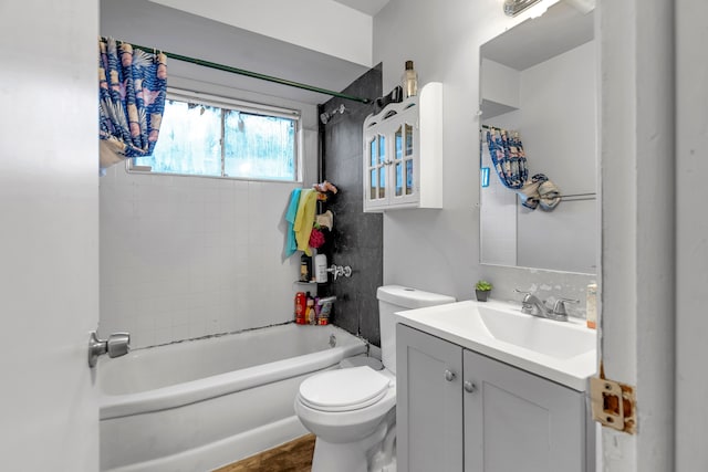 full bathroom with vanity, toilet, and tiled shower / bath combo