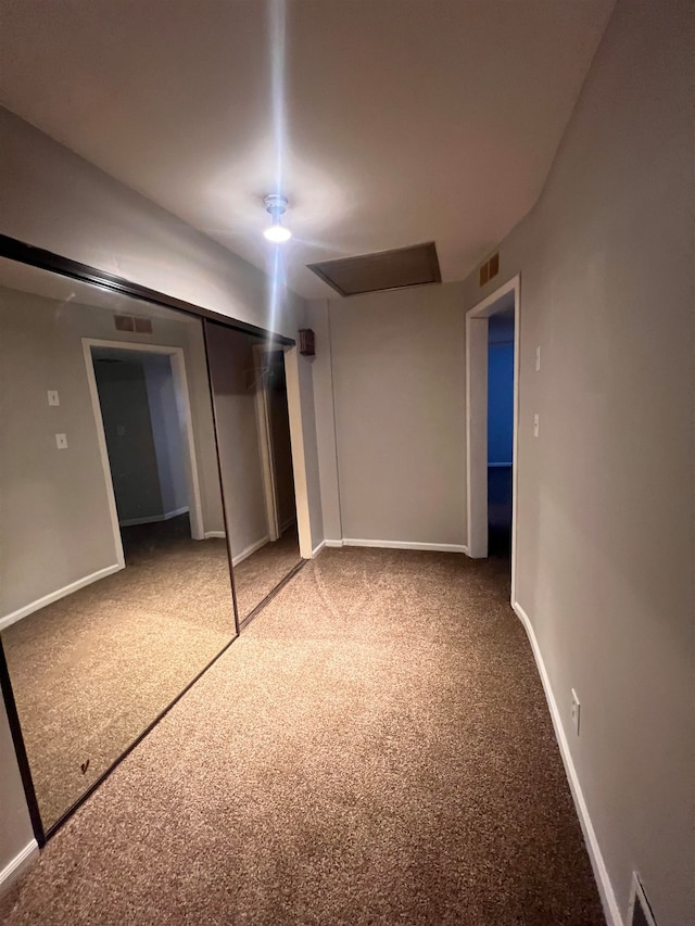 unfurnished bedroom featuring carpet and a closet