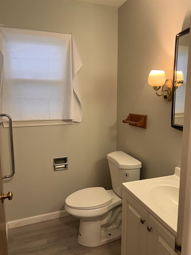 2910 Shawnee Ave, Flint, MI 48507 - bathroom with wood finished floors, toilet, vanity, and baseboards