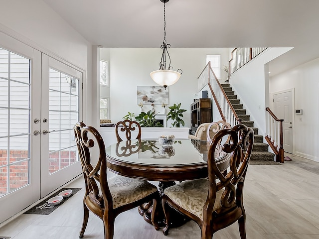 tiled dining area featuring french doors and a healthy amount of sunlight