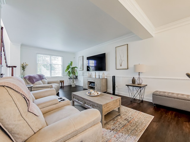 living room featuring dark hardwood / wood-style flooring, ornamental molding, and a fireplace