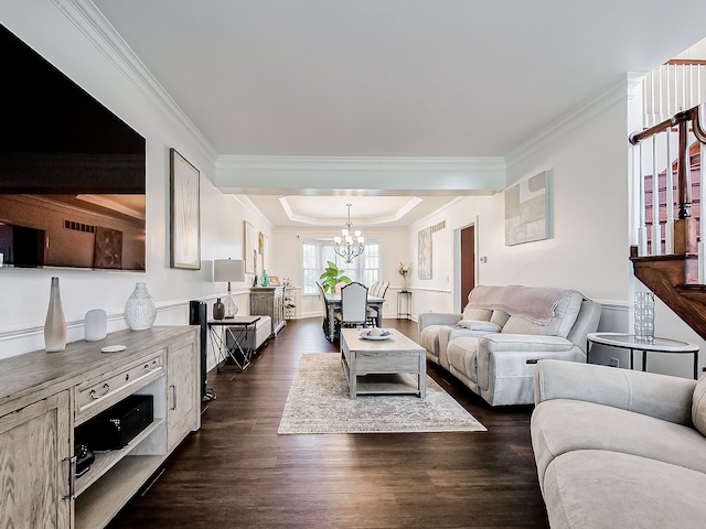 living room with crown molding, dark hardwood / wood-style flooring, and a chandelier