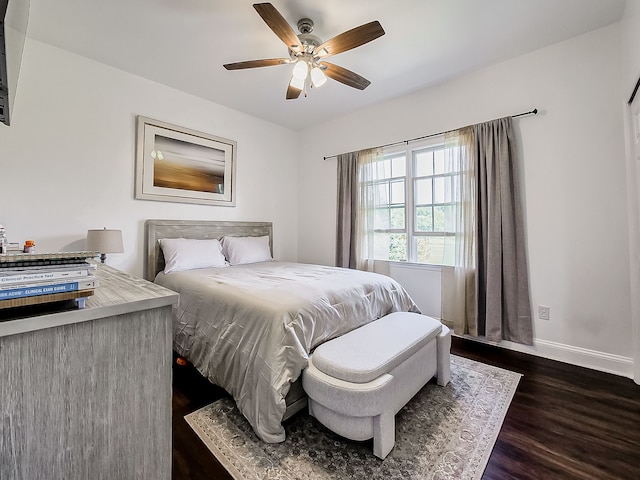 bedroom with ceiling fan and dark wood-type flooring