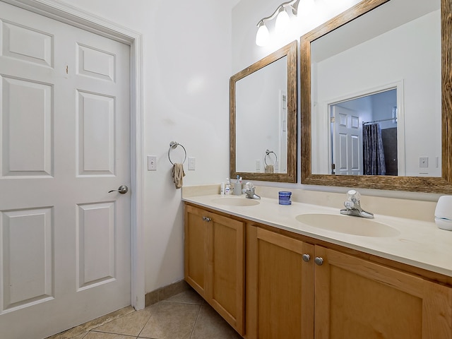 bathroom with tile patterned floors and vanity