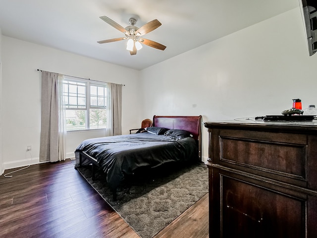 bedroom featuring ceiling fan and dark hardwood / wood-style flooring