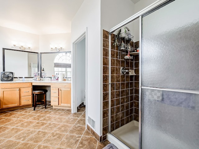 bathroom featuring tile patterned flooring, vanity, and walk in shower