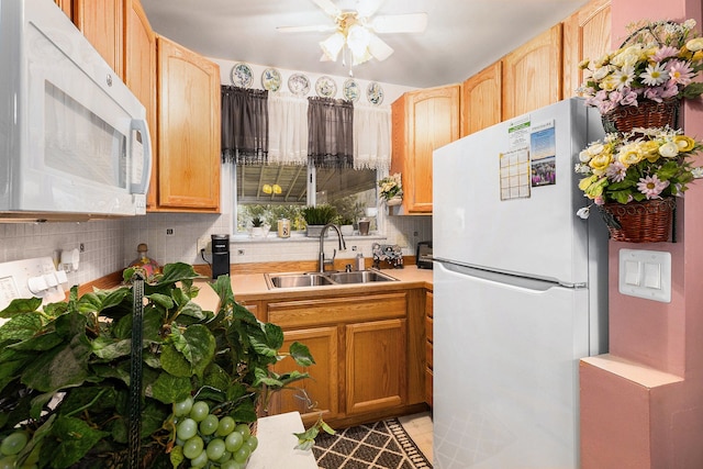 kitchen with white appliances, tasteful backsplash, ceiling fan, and sink