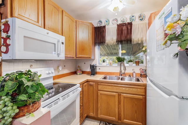 kitchen with decorative backsplash, ceiling fan, white appliances, and sink