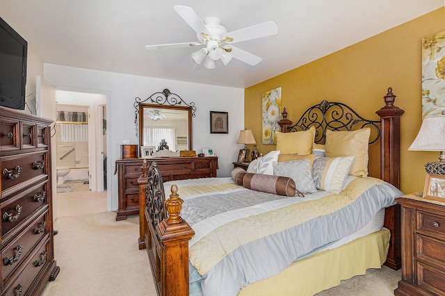 carpeted bedroom featuring ceiling fan and ensuite bathroom