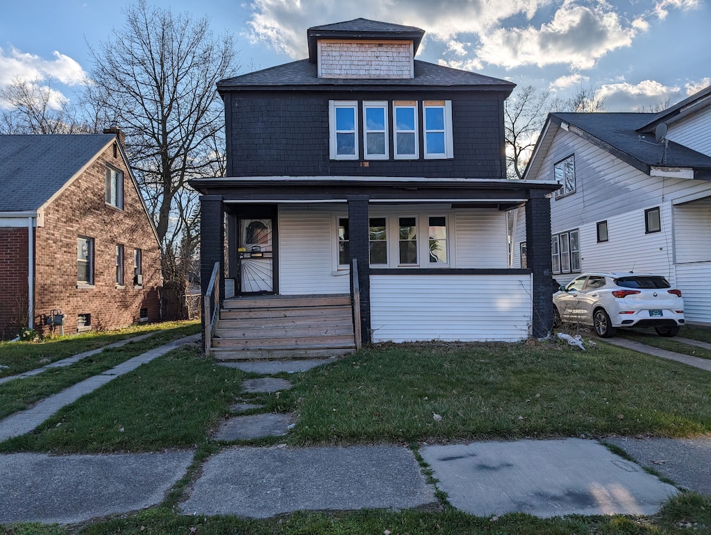 view of front facade with a porch and a front lawn