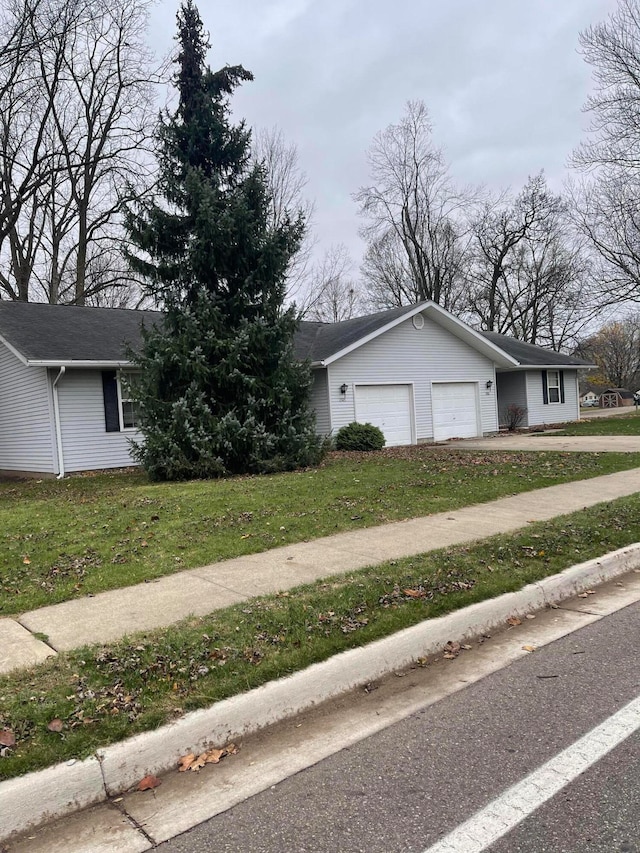 view of front of house with a front yard and a garage