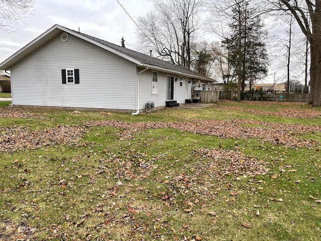 rear view of house featuring a lawn