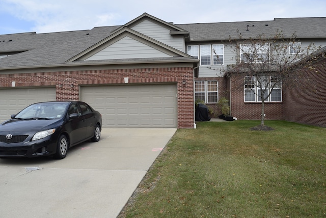 view of front of house featuring a front yard and a garage