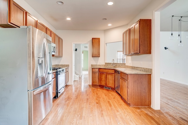 kitchen with light hardwood / wood-style flooring, stainless steel appliances, and sink