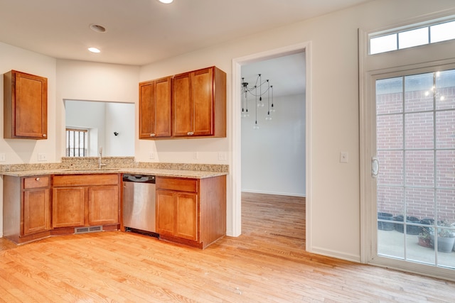 kitchen with stainless steel dishwasher, light wood-type flooring, and sink