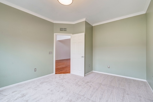 carpeted empty room featuring ornamental molding