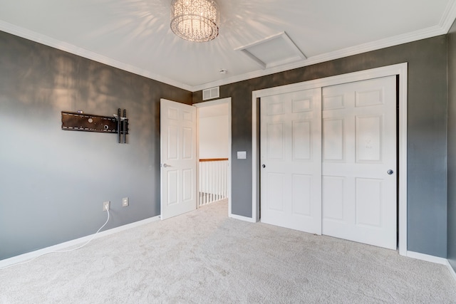 unfurnished bedroom featuring carpet, crown molding, and a closet