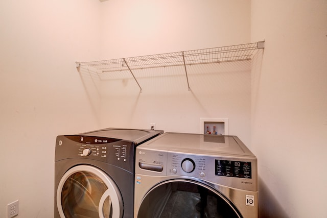 washroom featuring washing machine and clothes dryer