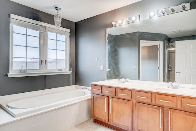 bathroom featuring tile patterned floors, vanity, and shower with separate bathtub