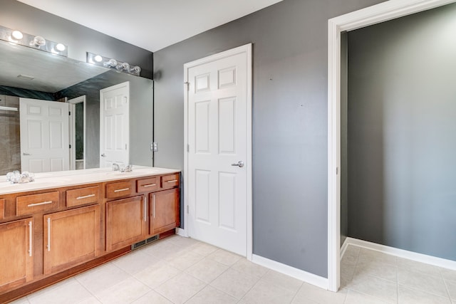 bathroom with tile patterned flooring and vanity