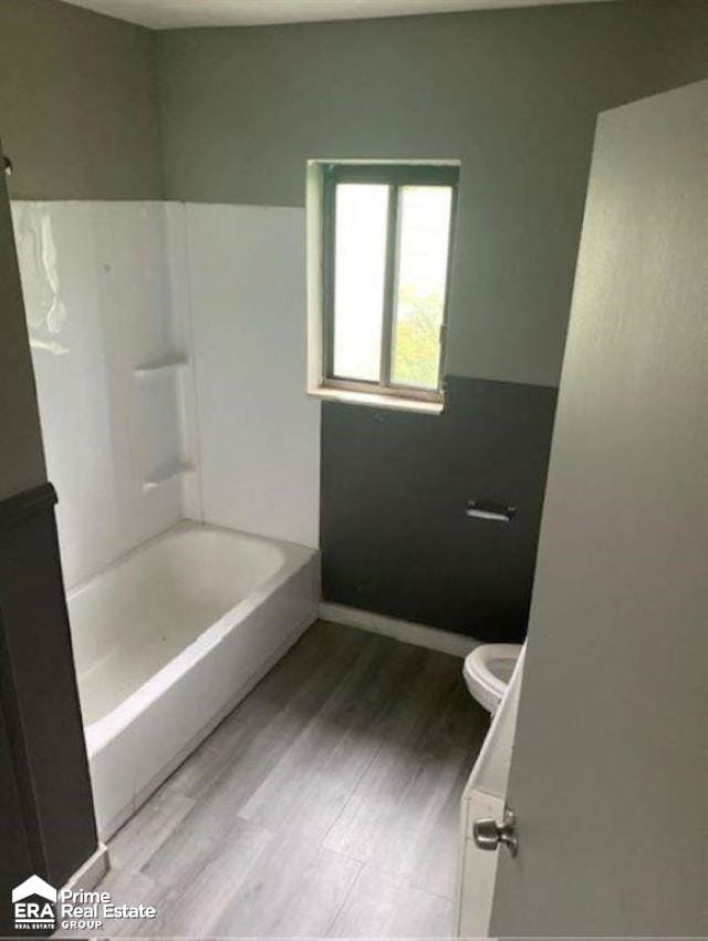 bathroom with hardwood / wood-style flooring and toilet