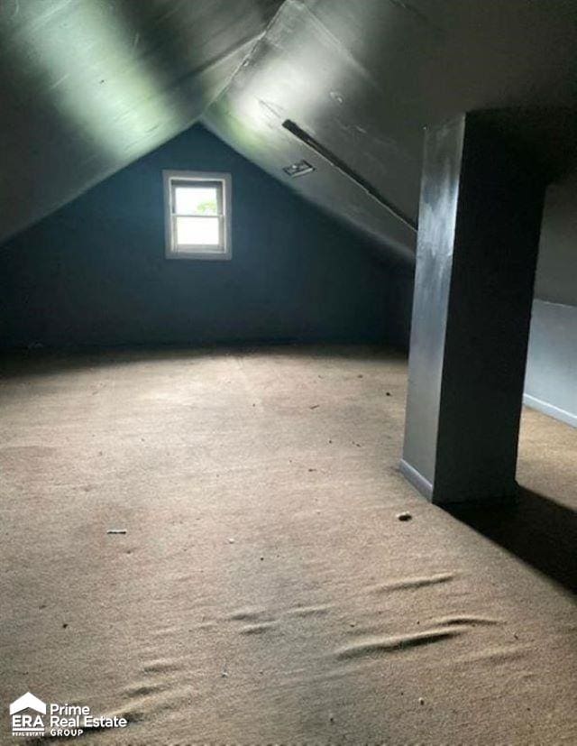 bonus room with carpet flooring and lofted ceiling