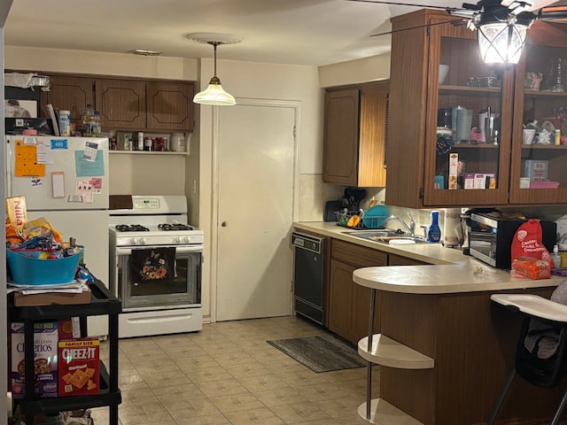 kitchen with pendant lighting, white appliances, sink, ceiling fan, and kitchen peninsula