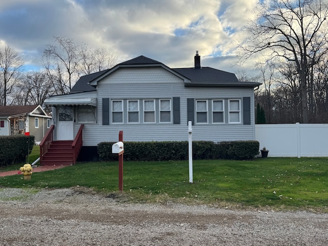 bungalow-style home with a front yard