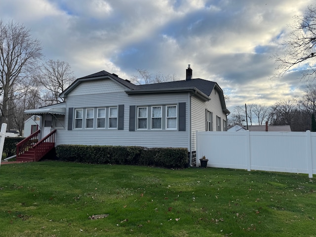 view of property exterior featuring a lawn