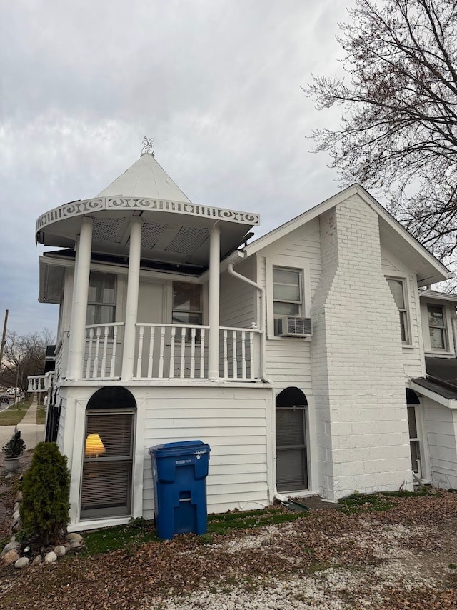 back of house with covered porch and cooling unit