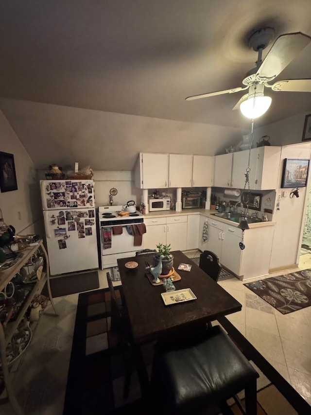 dining room featuring light tile patterned floors, ceiling fan, lofted ceiling, and sink