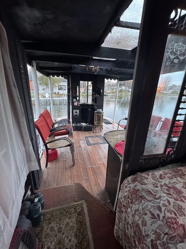 sunroom / solarium with a water view