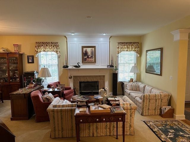 carpeted living room featuring a healthy amount of sunlight and a tile fireplace