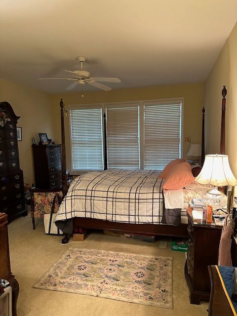 bedroom with ceiling fan and carpet floors