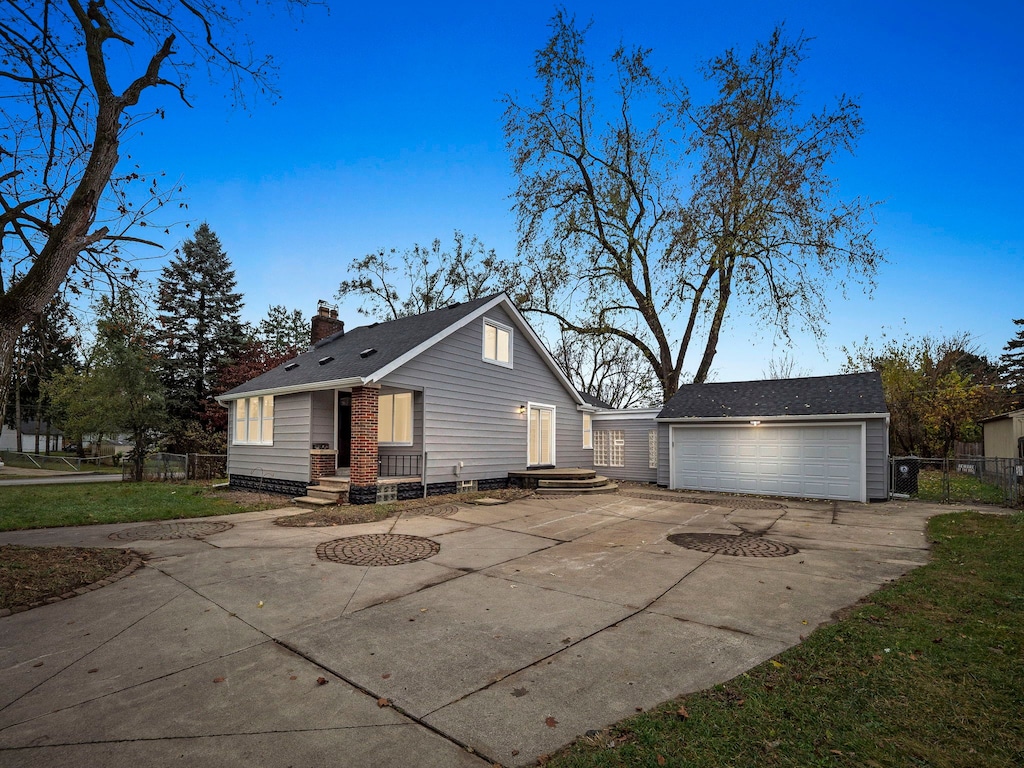 view of side of property featuring a garage and an outbuilding