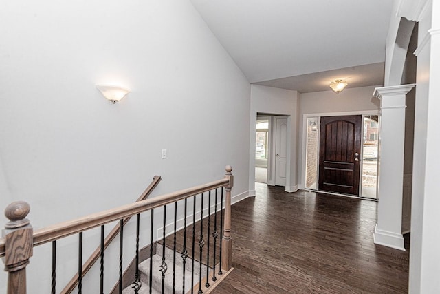 entrance foyer with dark hardwood / wood-style flooring, ornate columns, and lofted ceiling