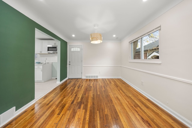 empty room with light hardwood / wood-style floors