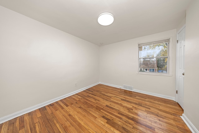 unfurnished room with wood-type flooring