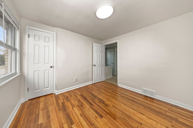 spare room with hardwood / wood-style floors