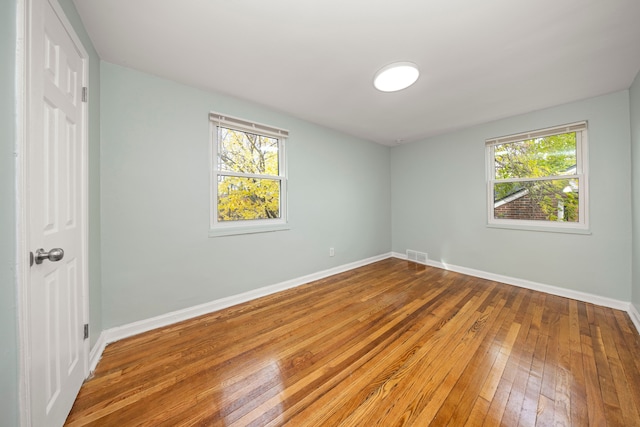 unfurnished room featuring hardwood / wood-style flooring