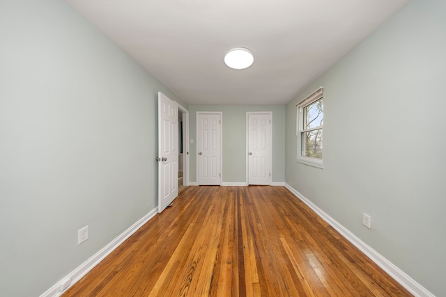 unfurnished bedroom featuring hardwood / wood-style flooring