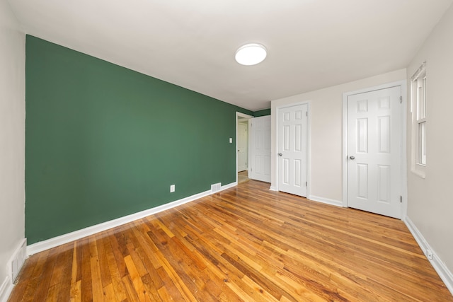 unfurnished bedroom featuring light wood-type flooring