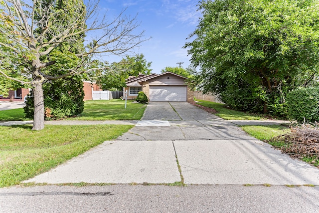 view of front of house featuring a garage and a front lawn