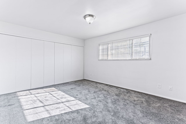 unfurnished bedroom featuring carpet floors and a closet