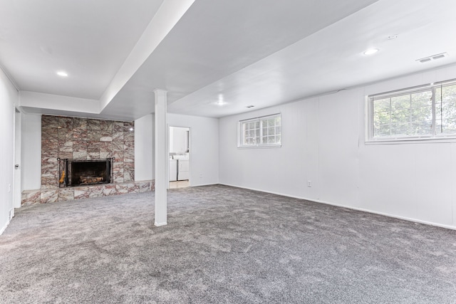 basement with a fireplace and carpet floors