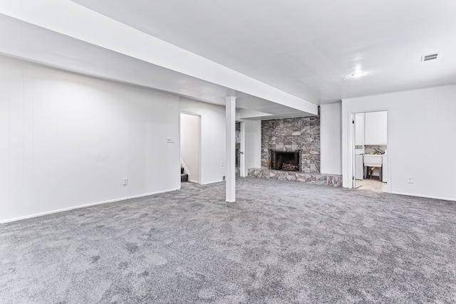 unfurnished living room featuring carpet and a fireplace